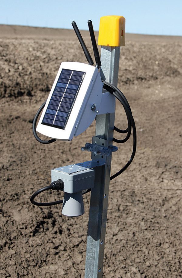 A deployed AlertCommunities sensor node: solar panel, LoRa antennas and ultrasonic water-level sensor on a galvanised pole
